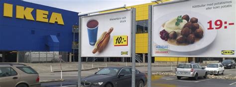A billboard advertizing the meatballs in front of an IKEA ...