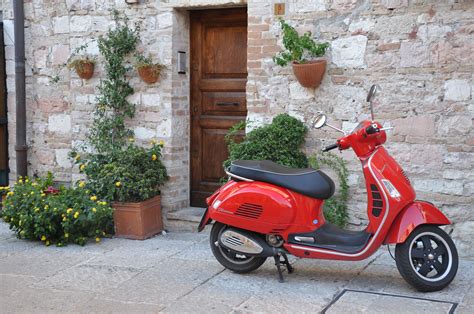 A Cute Vespa In front of its home in Assisi | Italian architecture ...