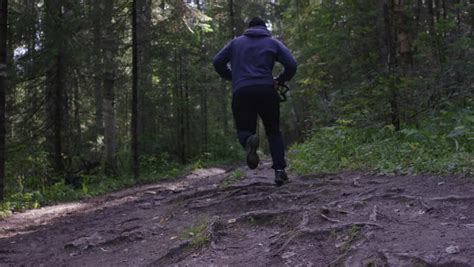 Athlete Running Through the Woods. Stock Footage Video ...