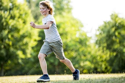 Boy running in park   Stock Image   F022/6975   Science Photo Library