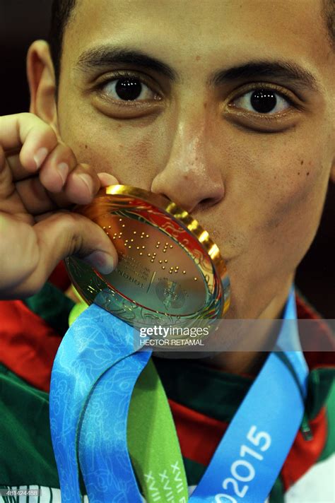 Carlos Navarro of Mexico poses with his gold medal in the Taekwondo ...