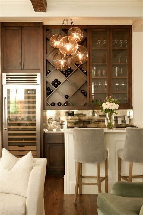 Chic living room bar features dark stained shaker cabinets ...