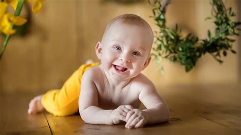 Cute Baby Is Lying Down On Floor With Smiley Face Wearing ...