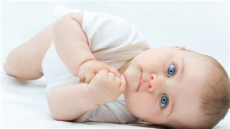 Cute Blue Eyes Baby Is Lying Down On Floor Wearing White ...