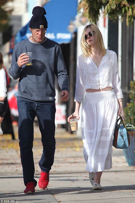 Elle Fanning looks angelic in all white as she pops out ...