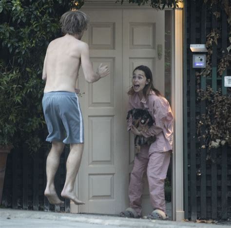 EMILIA CLARKE in Pyjamas with Her Dog Outside Her House in ...