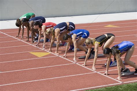 Female athletes in starting blocks ready to run Stock ...