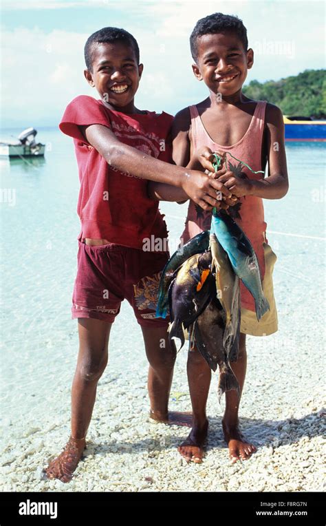 Fiji Islands, Yanuca Island, Fijian islander boys with fresh reef fish ...