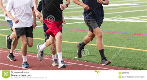 Five Boys Running Fast In A Group On A Track Stock Photo Image of ...