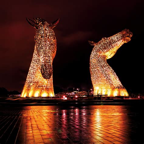 Kelpies monument lit up in yellow. Located in Falkirk ...
