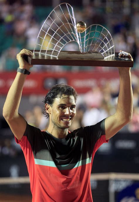 Nadal, of Spain holds up the trophy after winning against Dolgopolov in ...