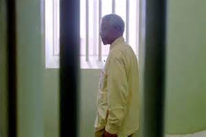 Nelson Mandela stands in the prison cell he occupied on ...