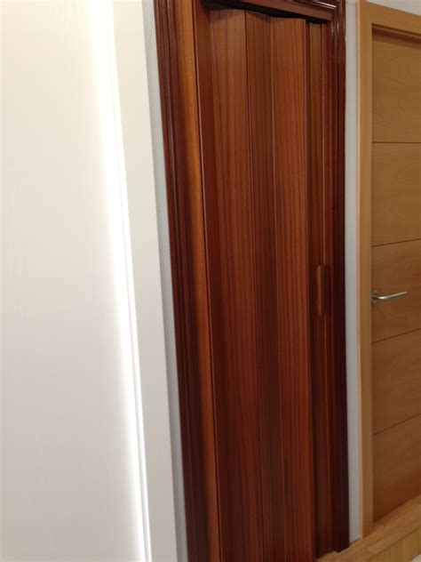 Puerta plegable en madera de Sapelly. | Home decor, Tall cabinet ...
