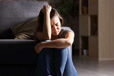 Sad Teen At Home In A Dark Living Room Stock Photo ...