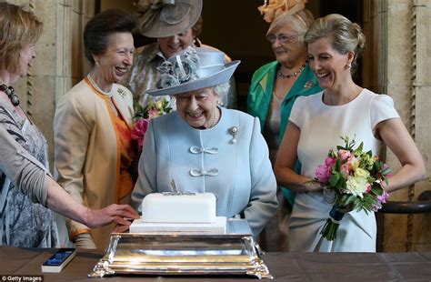 The Queen smiles as she cuts cake at WI meeting at Royal ...
