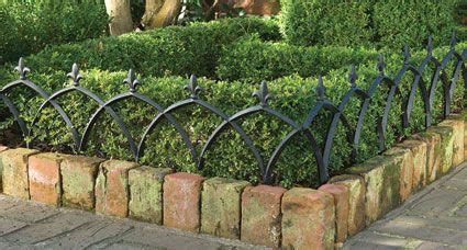 This aluminum garden fence adds a decorative touch to ...