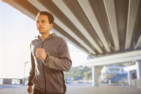 Young man jogging outdoors stock photo. Image of sport ...