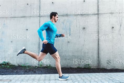 Young Man Running Outdoors In Morning Stock Photo   Download Image Now ...