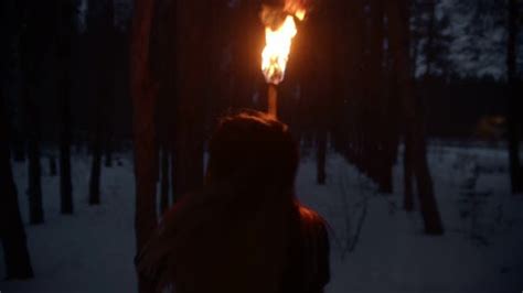 Young Scared Woman with Fire Torch Running From Danger in ...